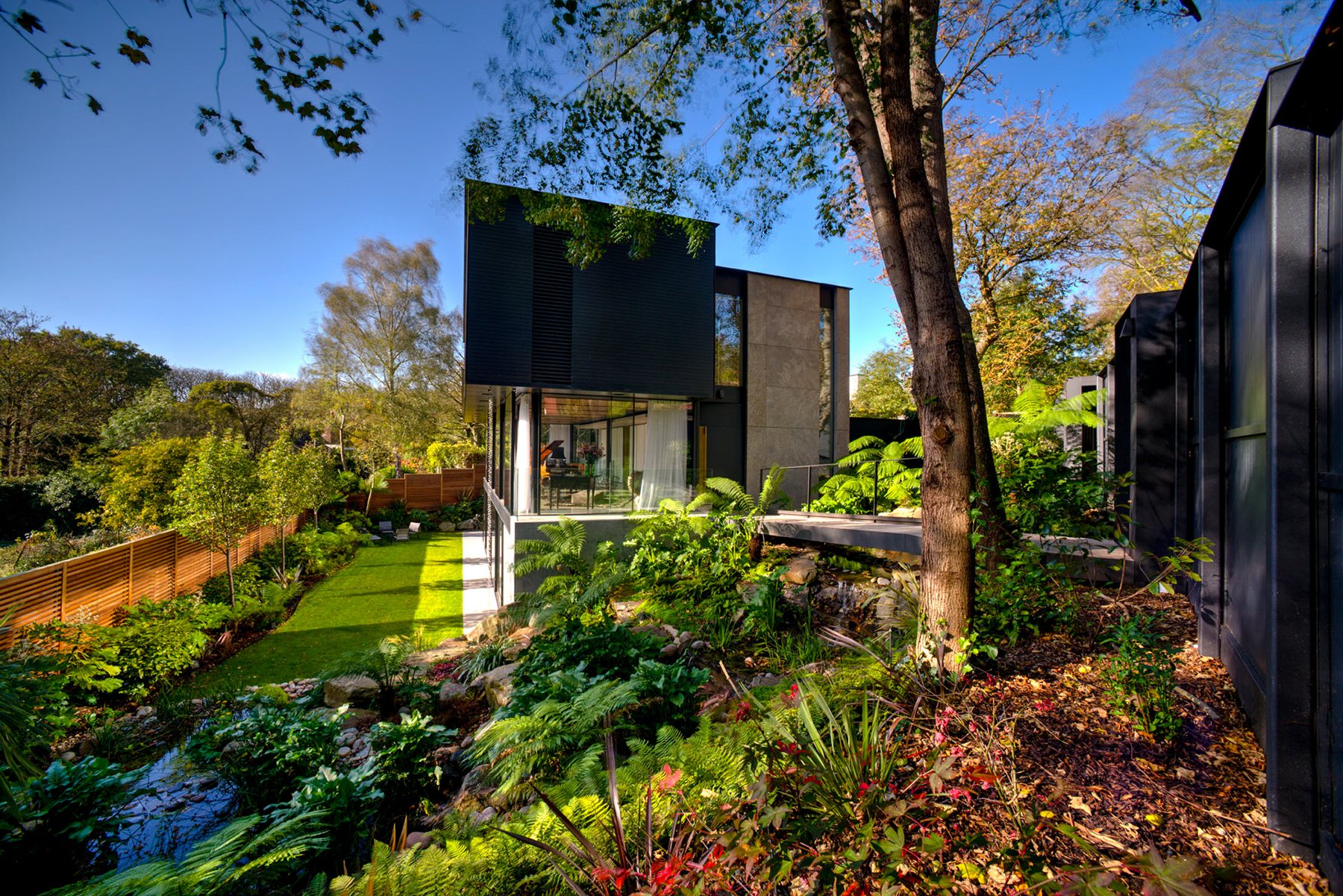 Fitzroy Park House in Highgate, a dark timber house set in a planted garden